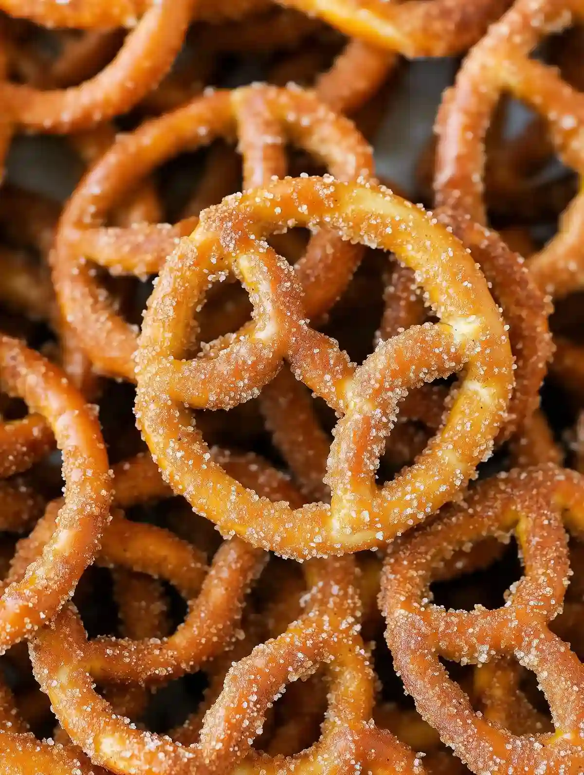 Golden-brown pretzels with a crunchy texture, arranged on marble.