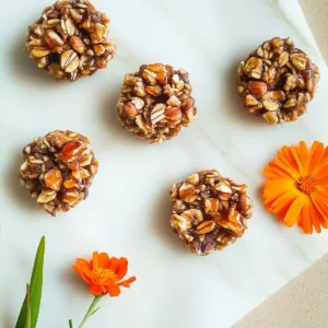 Golden oat and nut clusters with marigold flower and orange petals