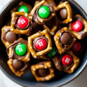 Bite-sized pretzels topped with melted chocolate and colorful M&Ms