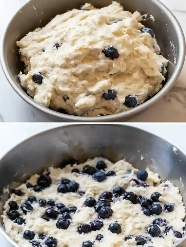 Dough with blueberries in a pan, ready for baking blueberry biscuits.
