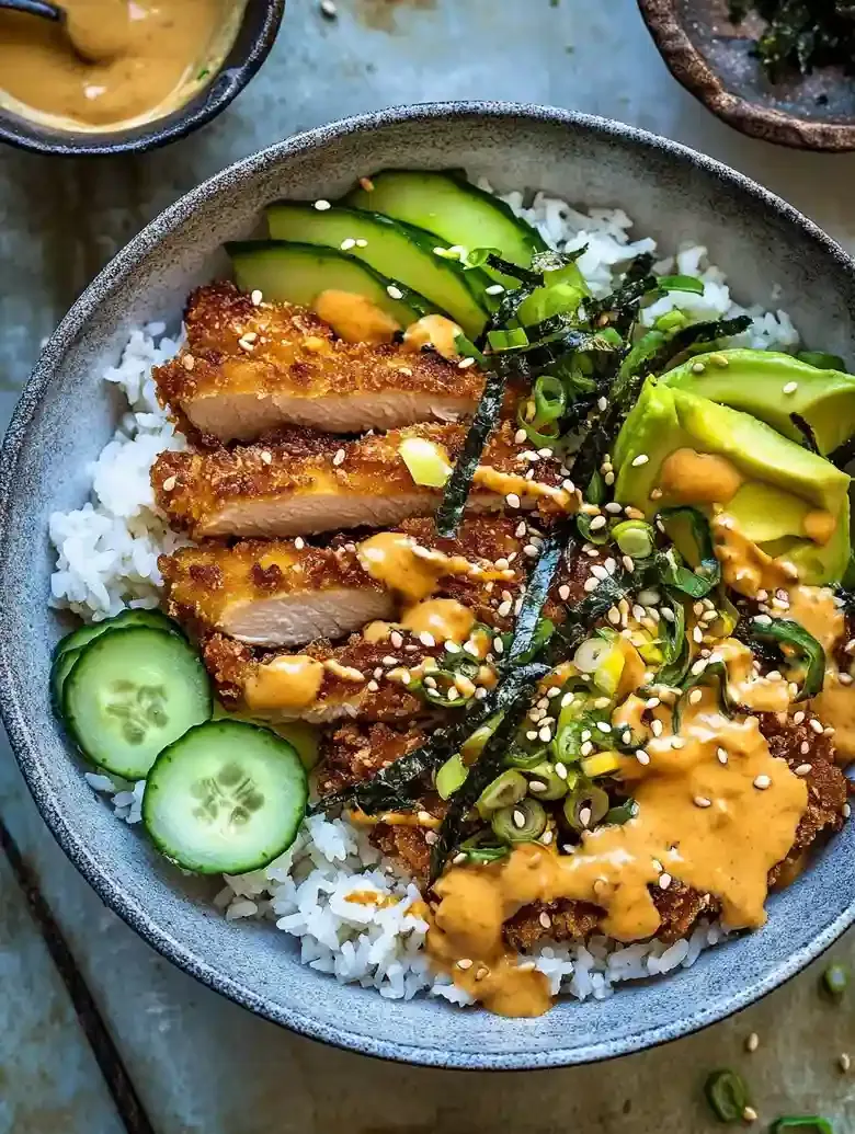 Crispy chicken katsu bowl with avocado, cucumber, edamame, and spicy mayo.