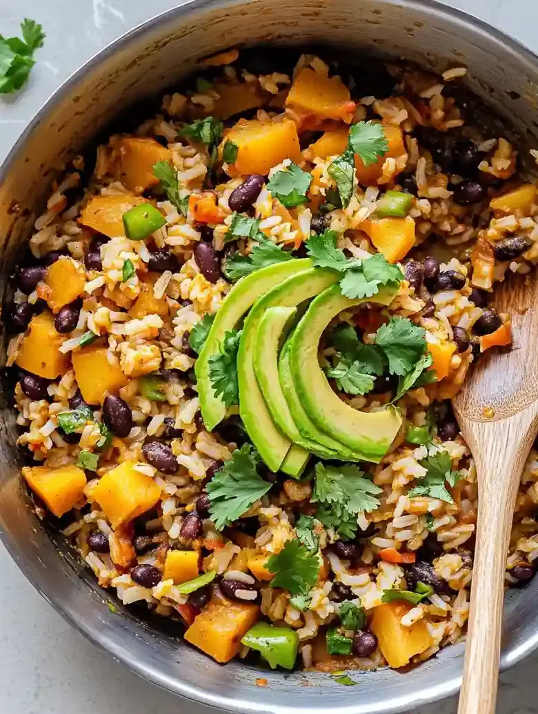 Southwest skillet with potatoes, black beans, rice, avocado, and cilantro.