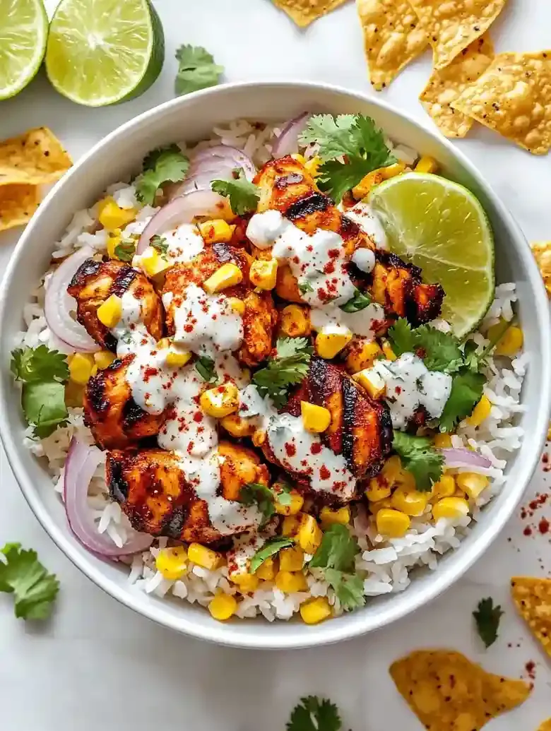 Street corn chicken rice bowl with grilled chicken, rice, corn, and lime.
